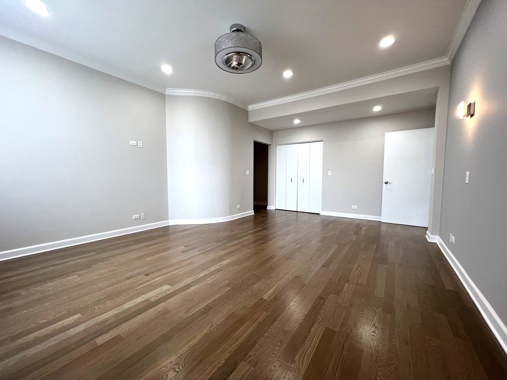 a living room with hardwood floors and white walls