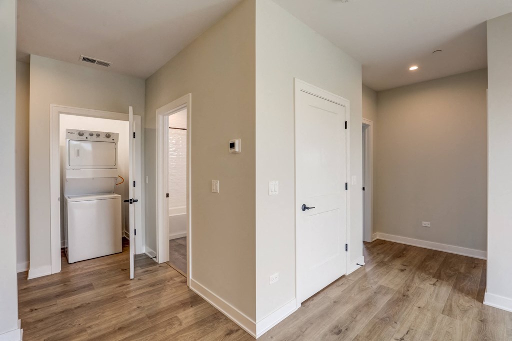 a renovated kitchen with a washer and dryer in a new home at Highwood 440, Illinois