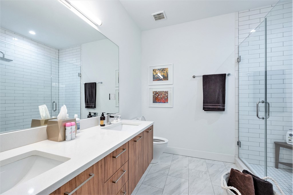 a bathroom with a large mirror and a sink and a shower at Wilmette 1121, Illinois, 60091