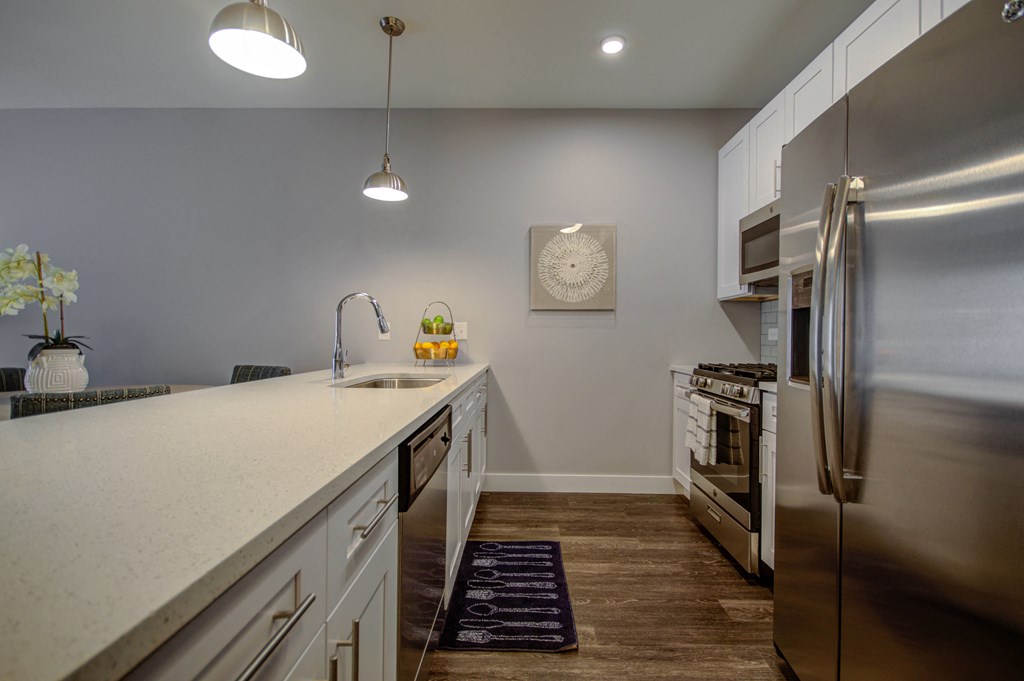 a kitchen with a large counter top and a stainless steel refrigerator at Barrington 101, Illinois