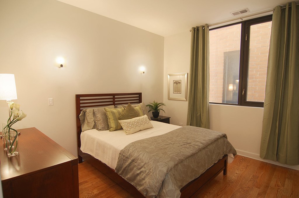 a bedroom with a bed and a window