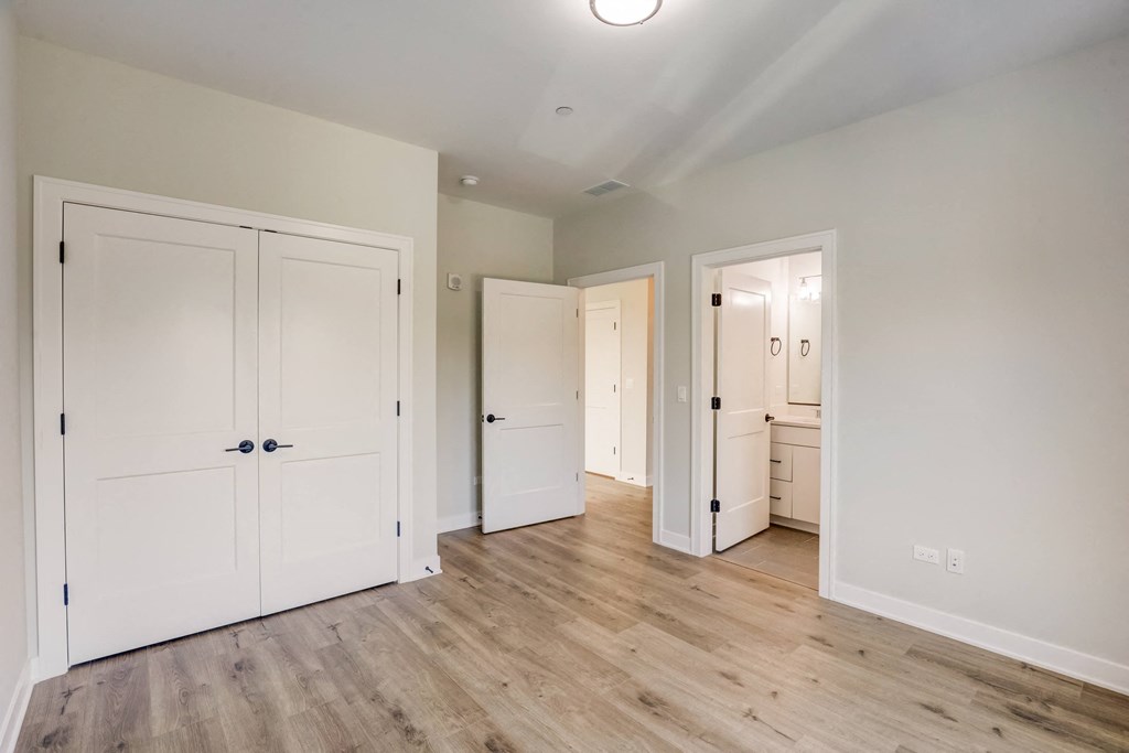 a renovated living room with white doors and wood floors at Highwood 440, Highwood