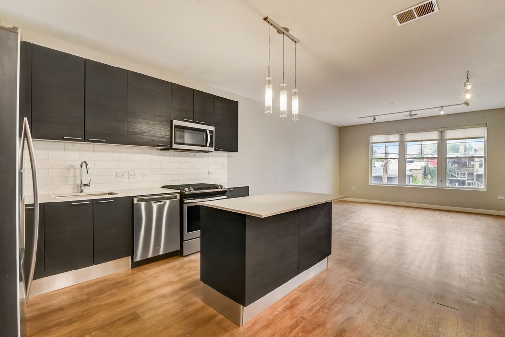 a kitchen with black cabinets and a white counter top at Clarendon Hills 229, Clarendon, IL 60514
