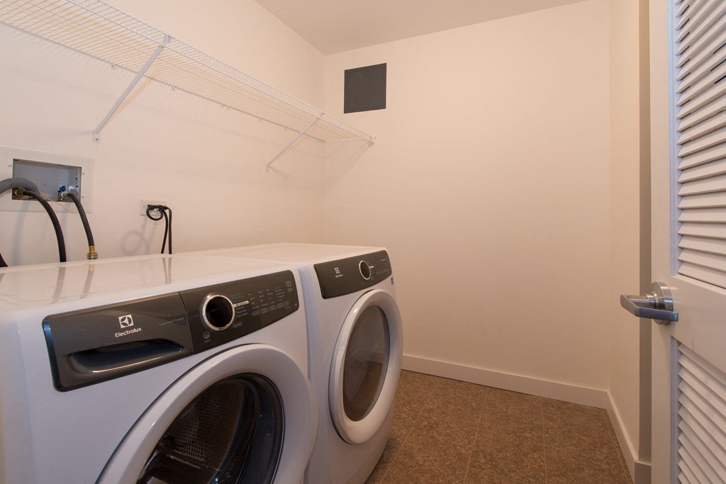 a washer and dryer in a laundry room with a window  at Kedzie 4447, Chicago