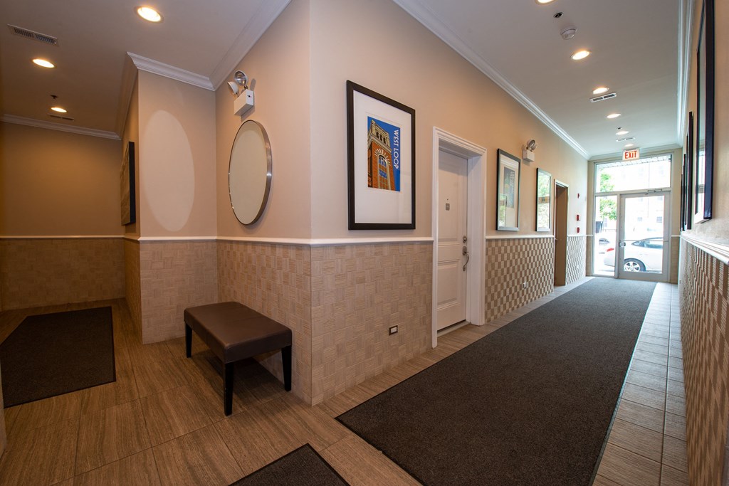 a hallway with a bench and a mirror and a door at Tripp 4321, Illinois