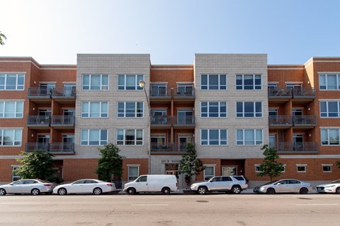 a large apartment building with cars parked in front of it  at Tripp 4321, Chicago, 60641