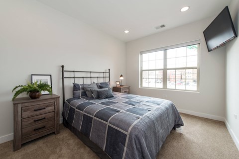 a bedroom with a bed and a window
