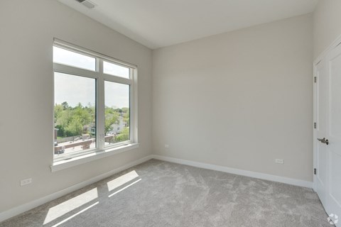 an empty living room with a large window
