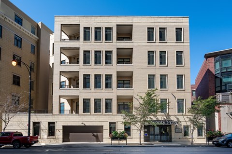 A large building with a garage door and a sign that says