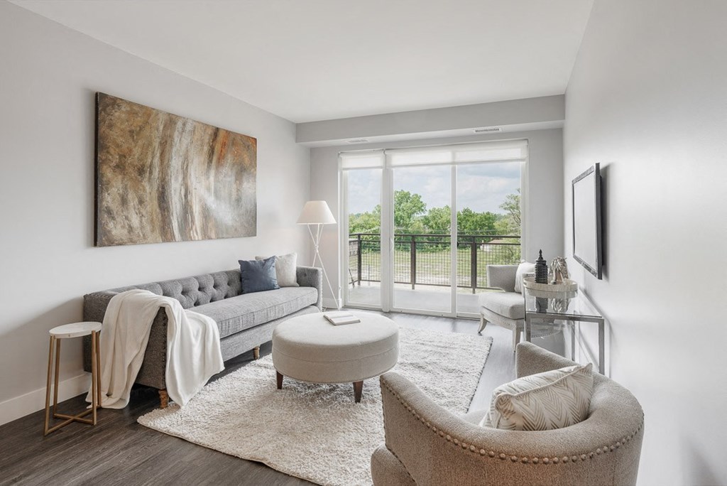 a living room with a couch and a chair and a balcony at Barrington 101, Barrington, IL 60010