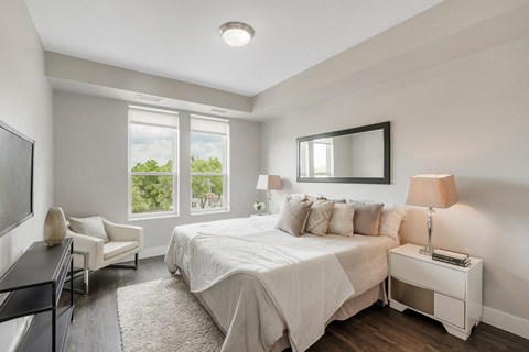 a white bedroom with a bed and a tv at Barrington 101, Illinois