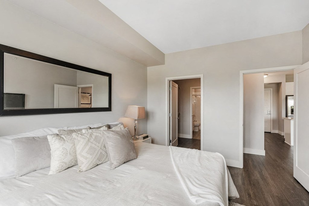 a bedroom with a large bed and a mirror at Barrington 101, Illinois, 60010