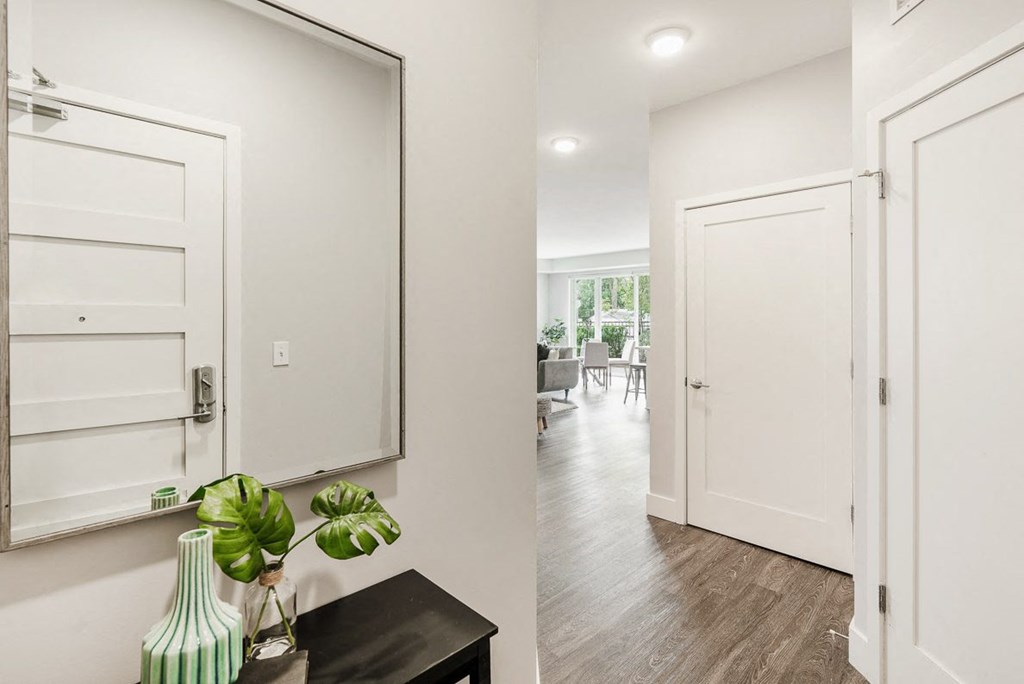 a hallway with white doors and a mirror at Barrington 101, Illinois, 60010 