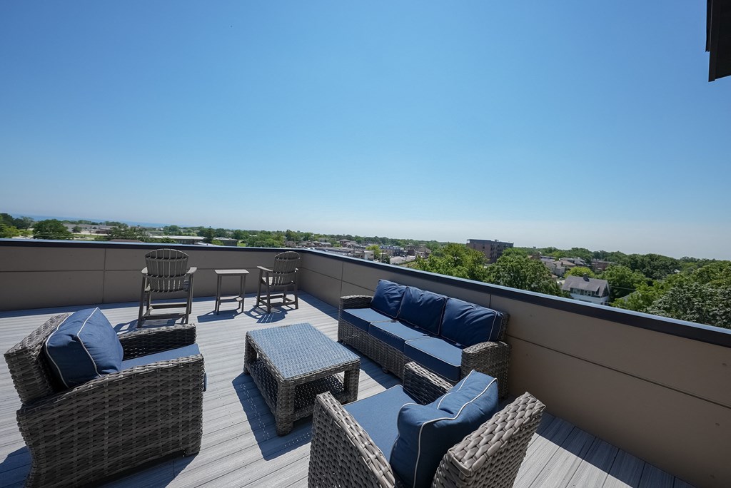 a roof deck with furniture and a view of the city