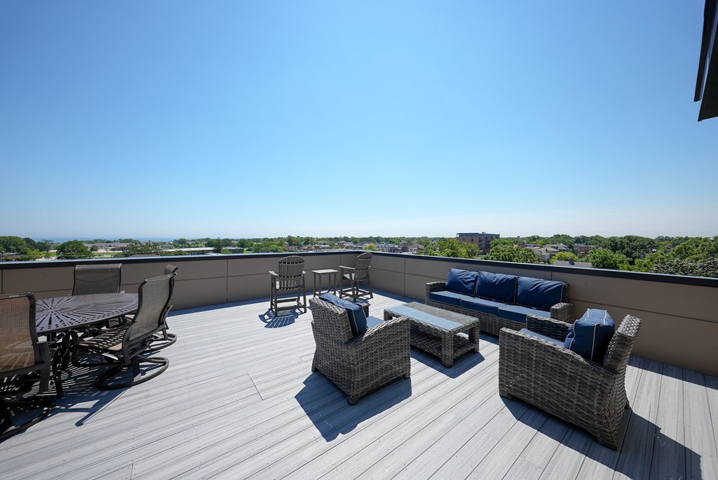 a roof deck with furniture and a view of the city
