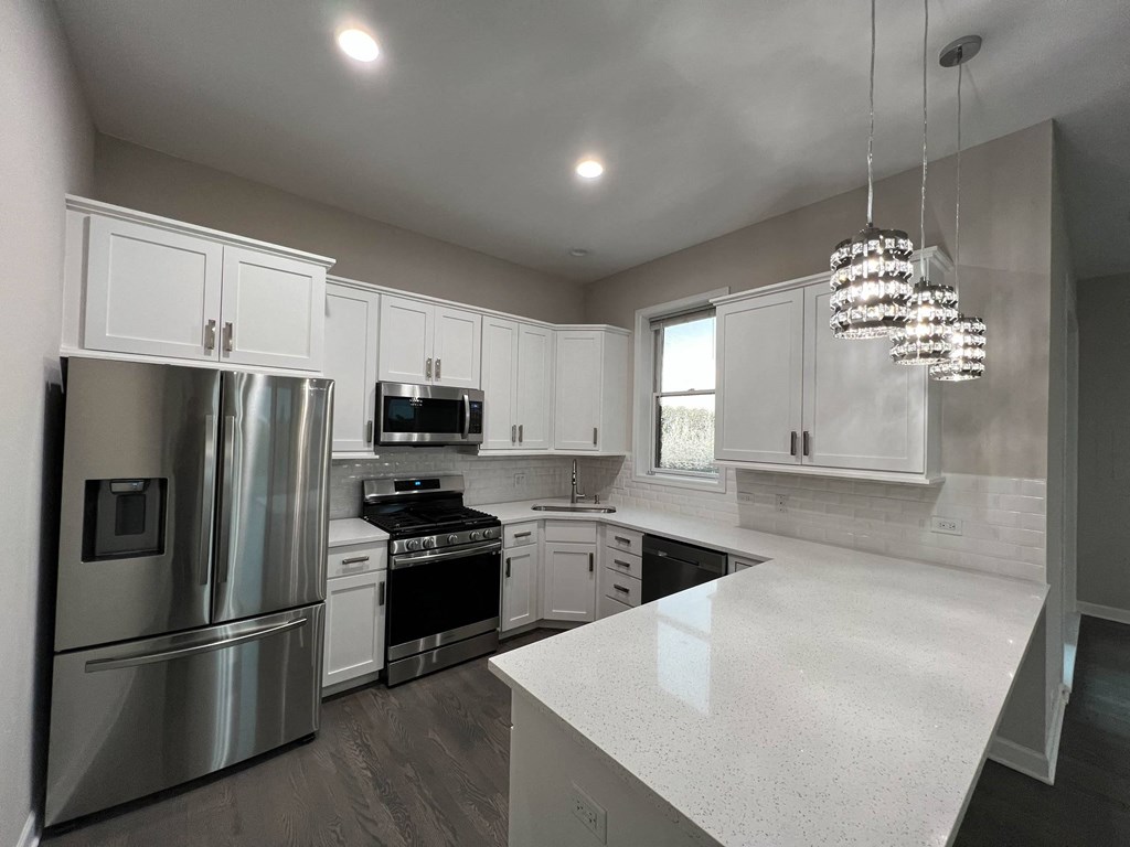 a kitchen with white cabinets and stainless steel appliances  at Elston 3434, Chicago