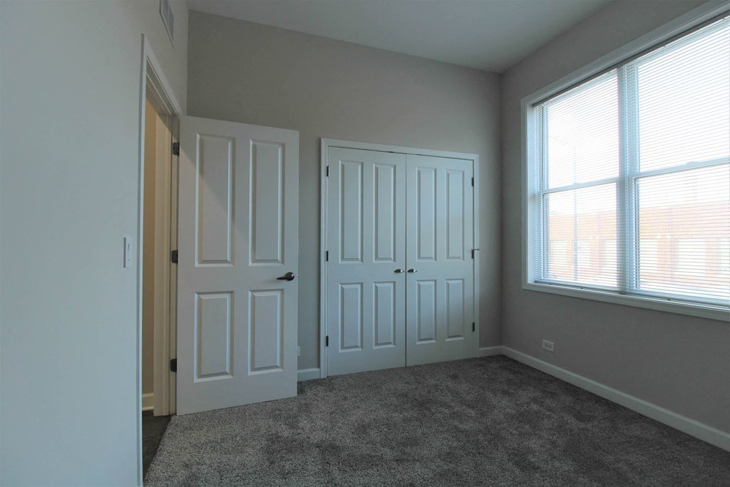 an empty bedroom with two doors and a window  at Elston 3434, Chicago, Illinois
