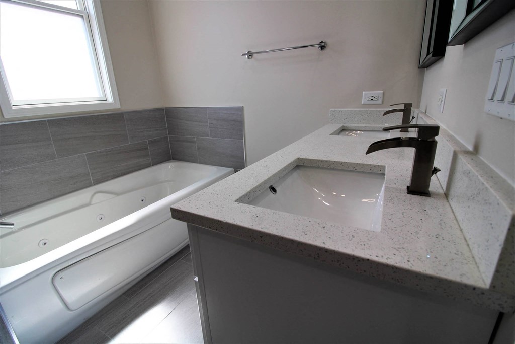 a bathroom with a sink and a bath tub  at Elston 3434, Illinois