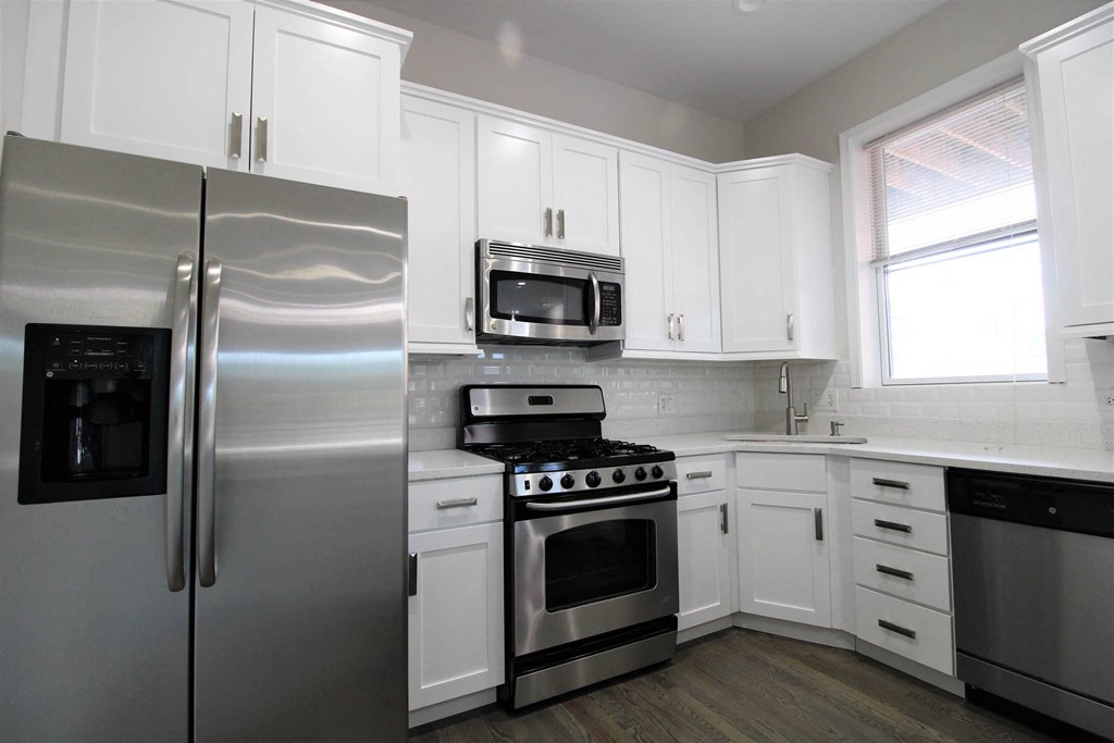 a kitchen with stainless steel appliances and white cabinets  at Elston 3434, Chicago, Illinois