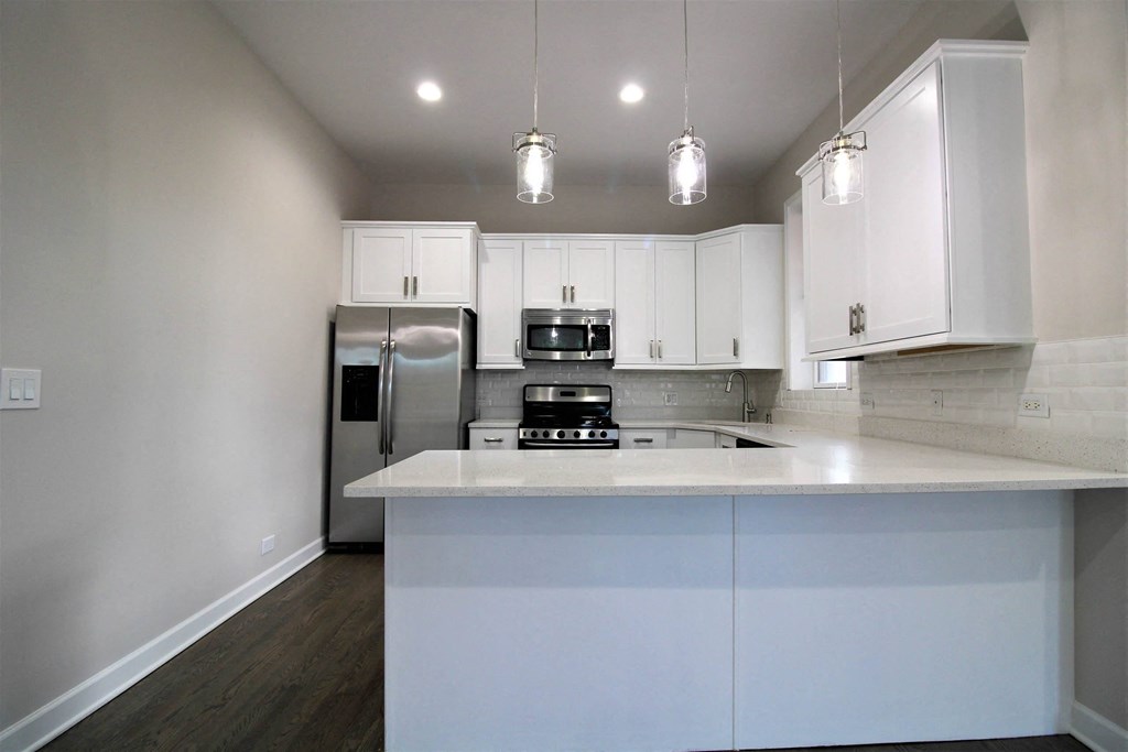 a kitchen with white cabinets and a counter top  at Elston 3434, Illinois, 60618