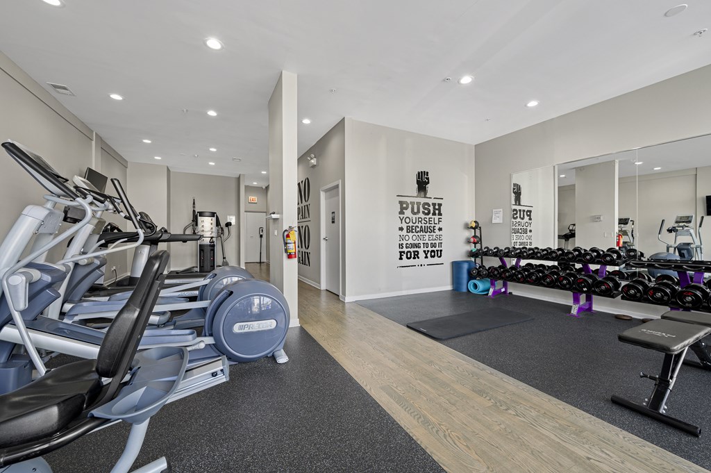 A gym with a row of treadmills and a sign that says