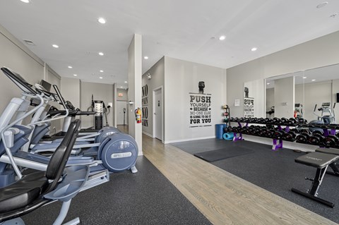 A gym with a row of treadmills and a sign that says