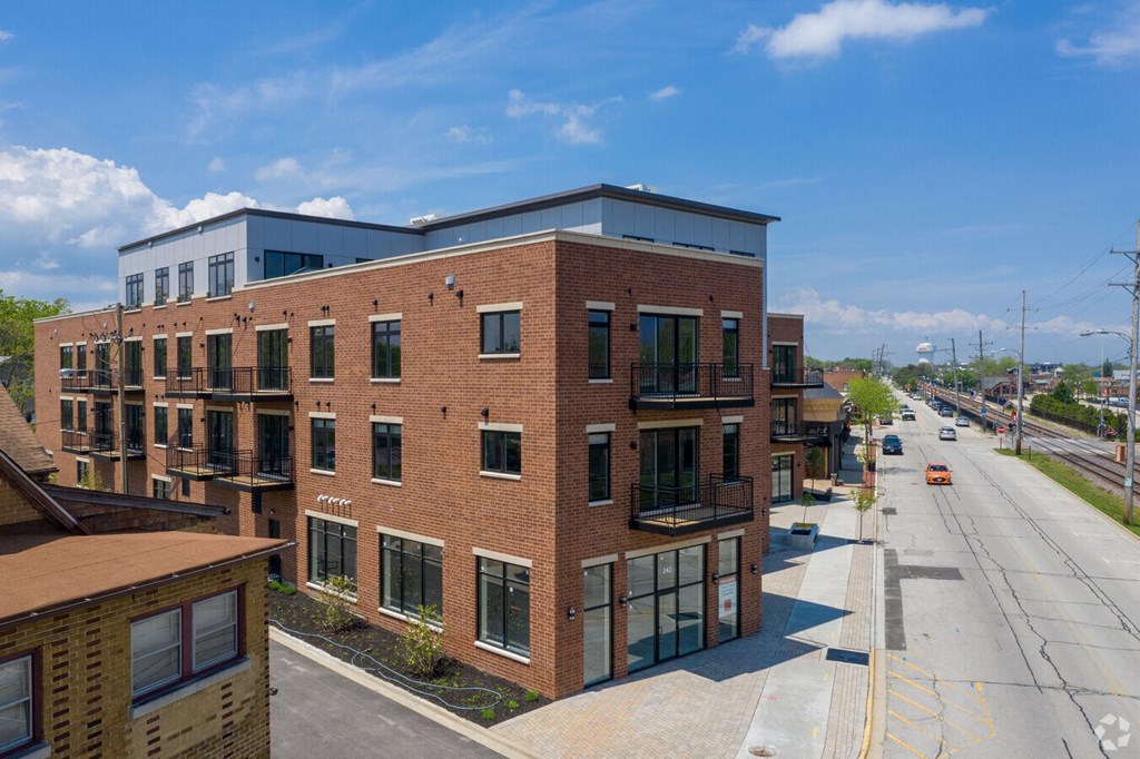 a large brick building with a street in front of it  at Highwood 246, Highwood