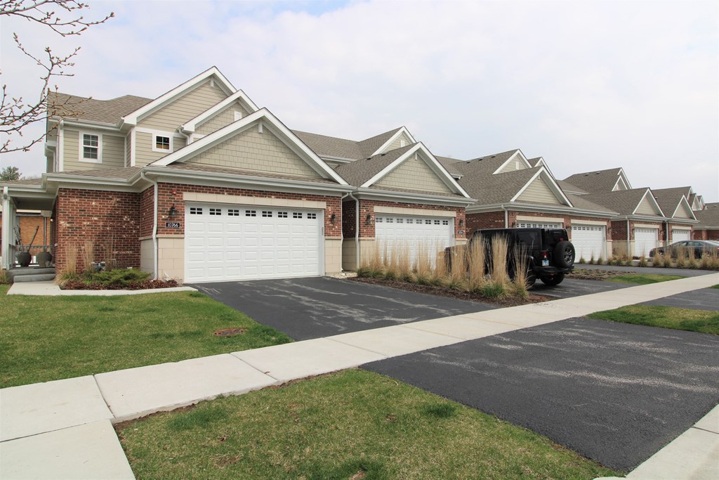 a house with a white garage door in front of it at Countryside Townhomes, Countryside, IL