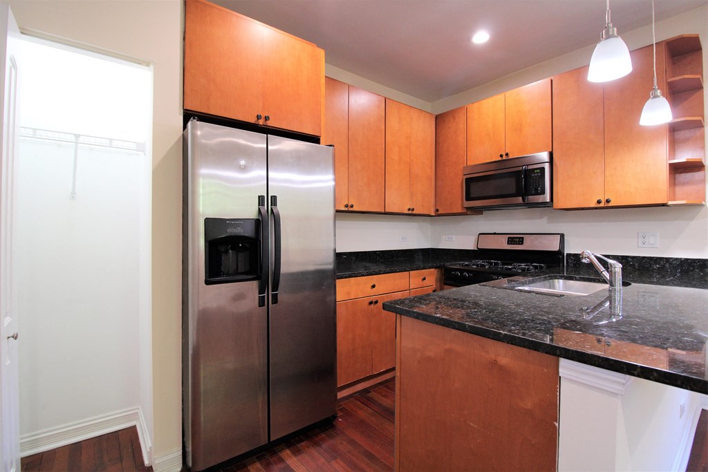 a kitchen with stainless steel appliances and granite counter tops at Tripp 4321, Chicago, 60641
