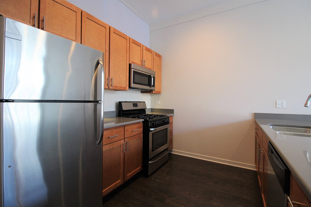 a kitchen with stainless steel appliances and wooden cabinets
