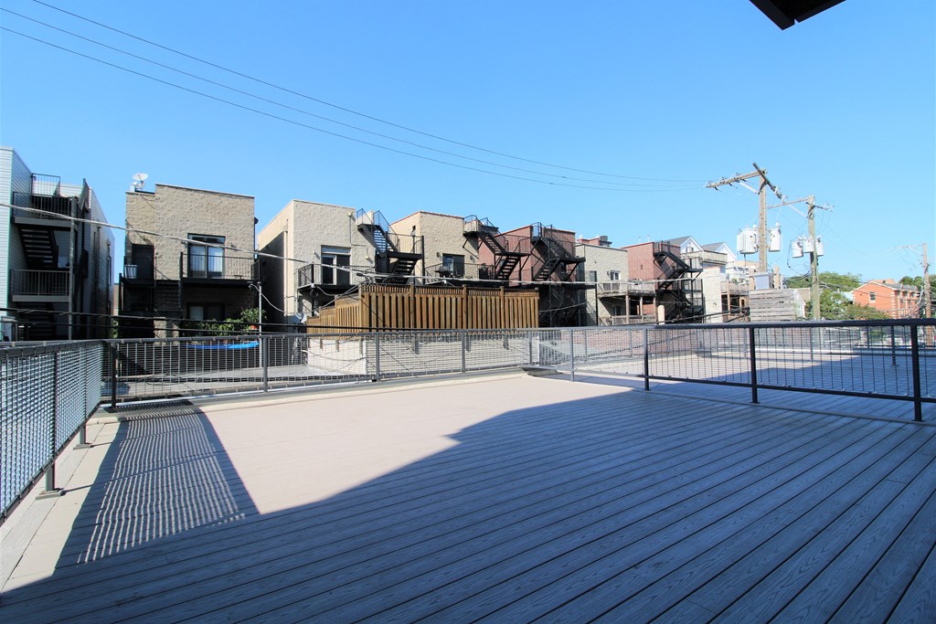 the deck on the top of the building has a fenced in area with fencing  at Fullerton 1540, Chicago, Illinois