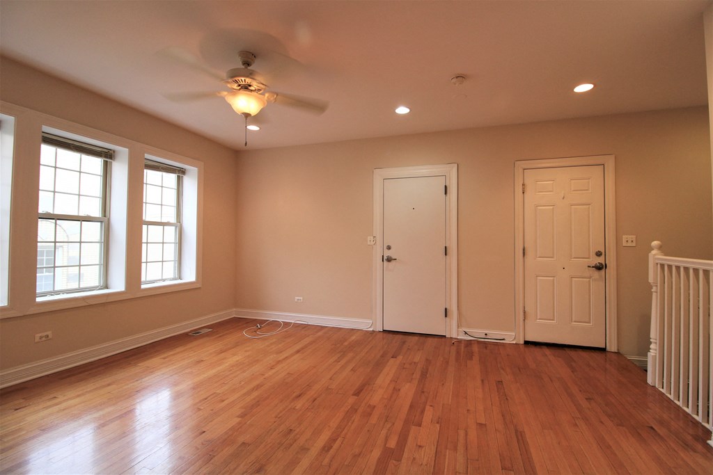 an empty living room with wooden floors and a ceiling fan at Christiana 4954, Illinois, 60625