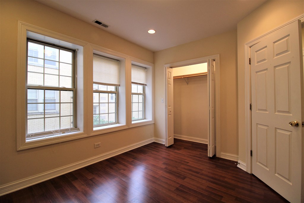 an empty living room with wood floors and large windows at Christiana 4954, Illinois
