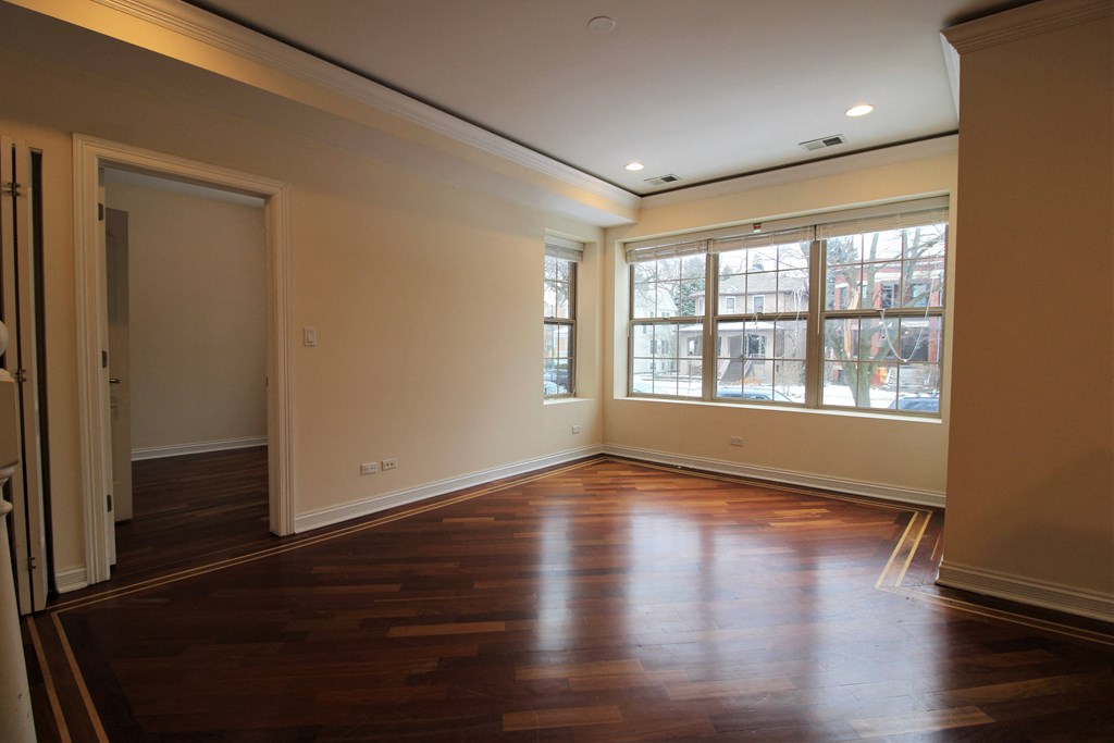 an empty living room with wooden floors and a large window at Tripp 4321, Illinois