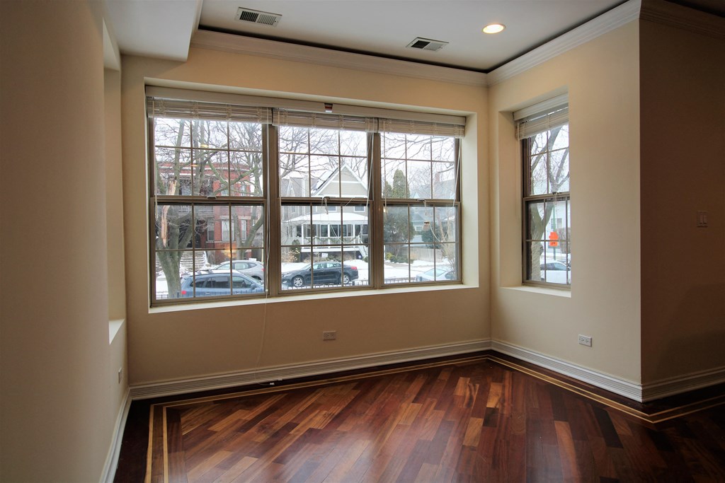 the living room of a new home with wood floors and large windows at Tripp 4321, Chicago, 60641