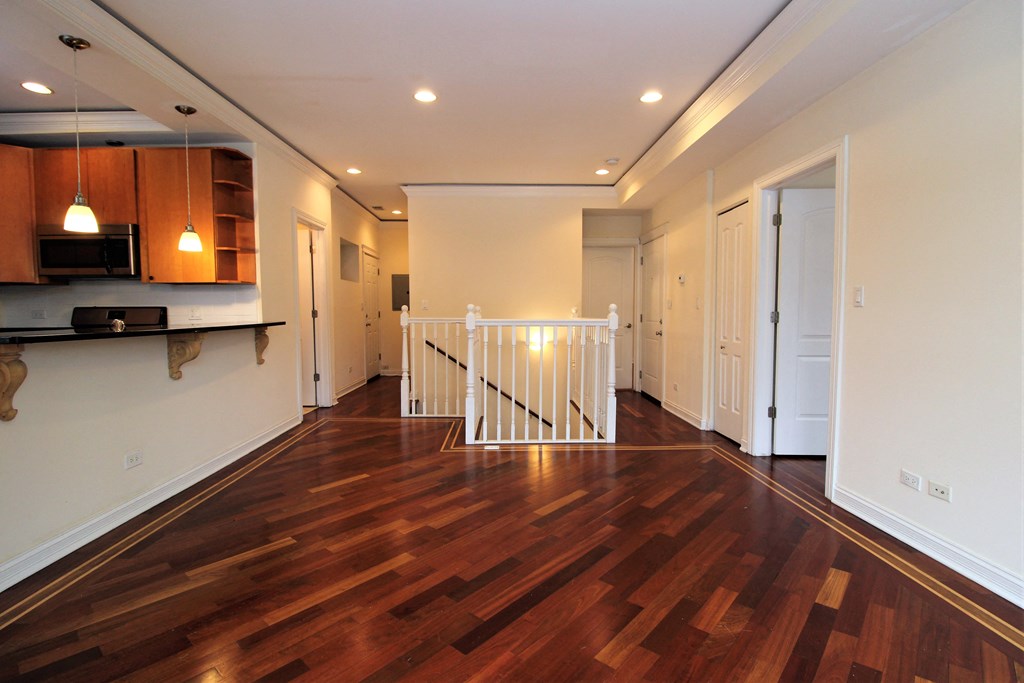 a living room with a hard wood floor and a staircase