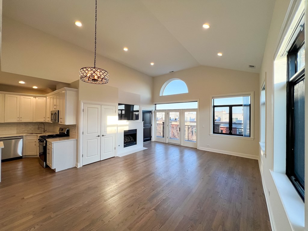 A modern kitchen with wooden floors and a large island.