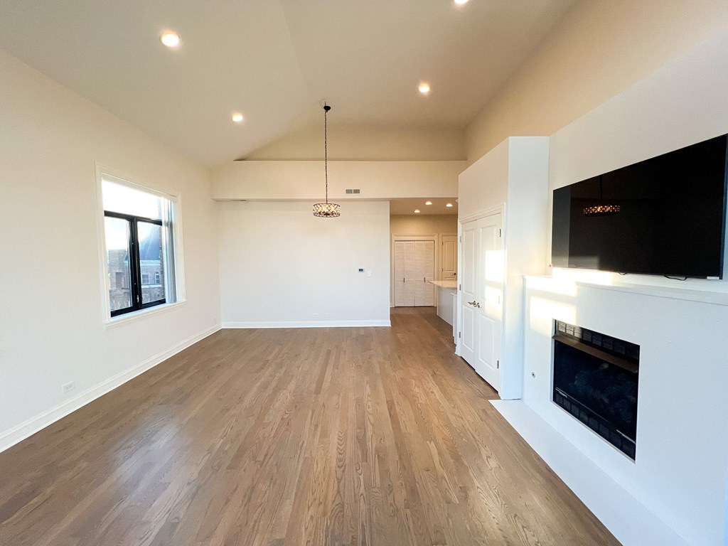 A spacious living room with a fireplace and a television.