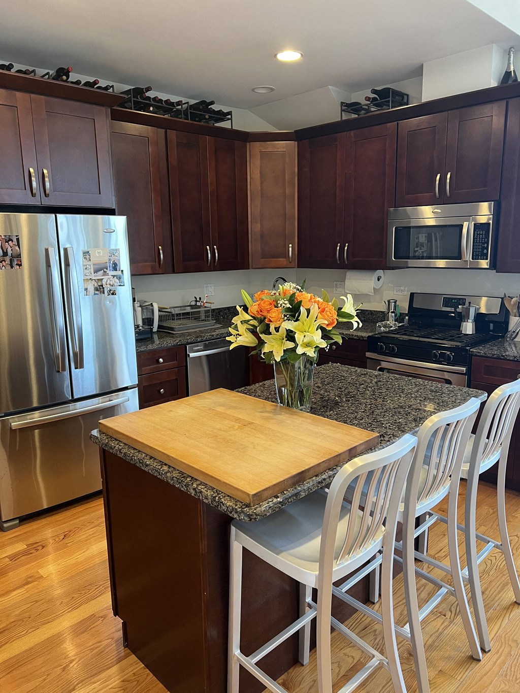 a kitchen with a center island and stainless steel appliances