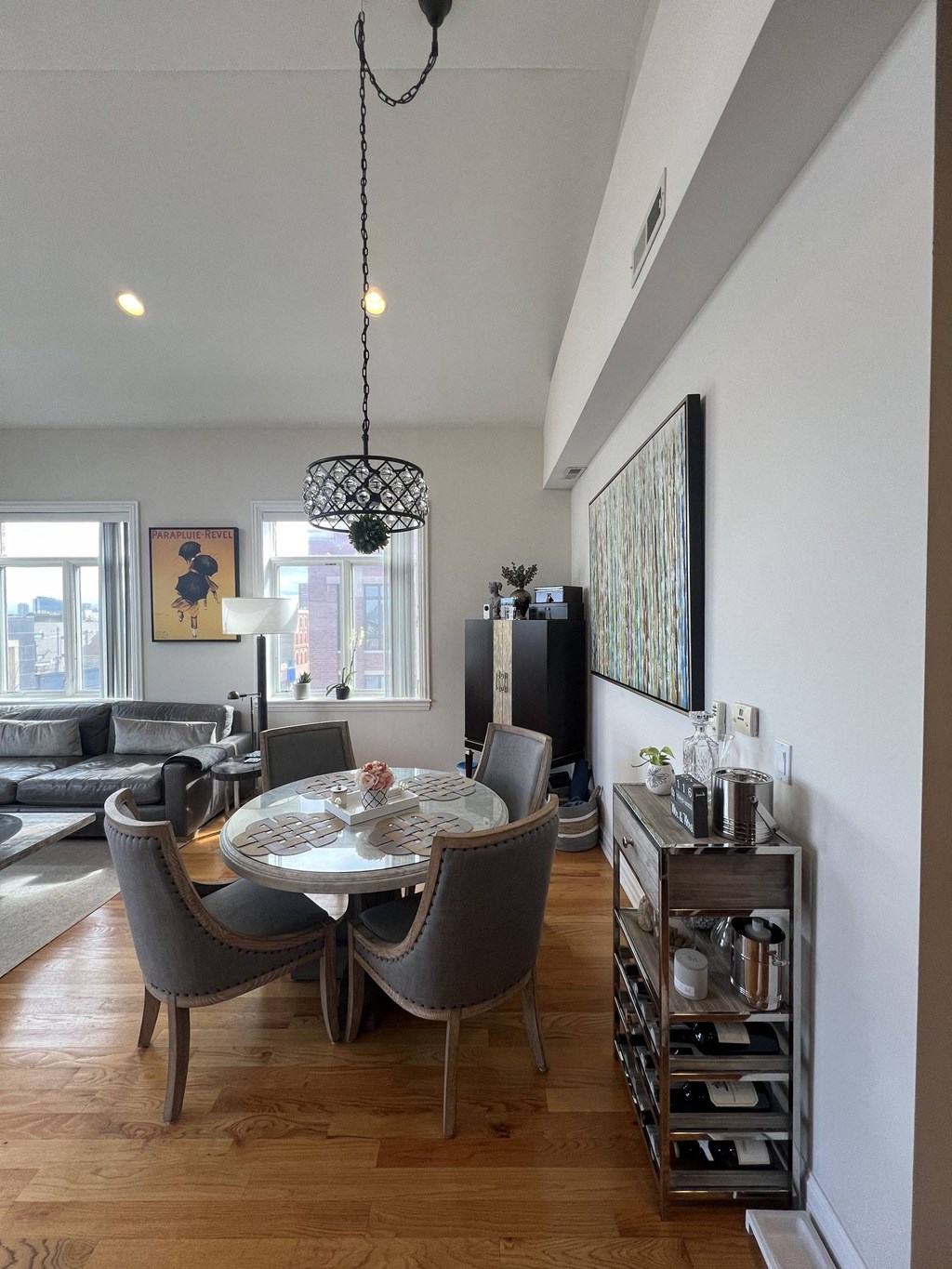 a dining room with a table and chairs and a living room with couches