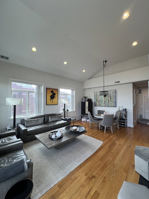 a large living room with couches and chairs and a dining room table