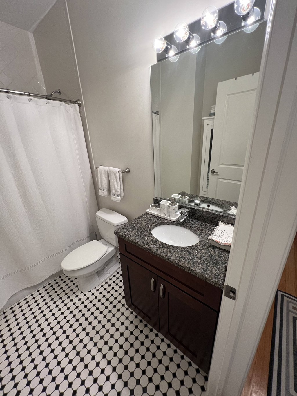 a small bathroom with a sink toilet and mirror