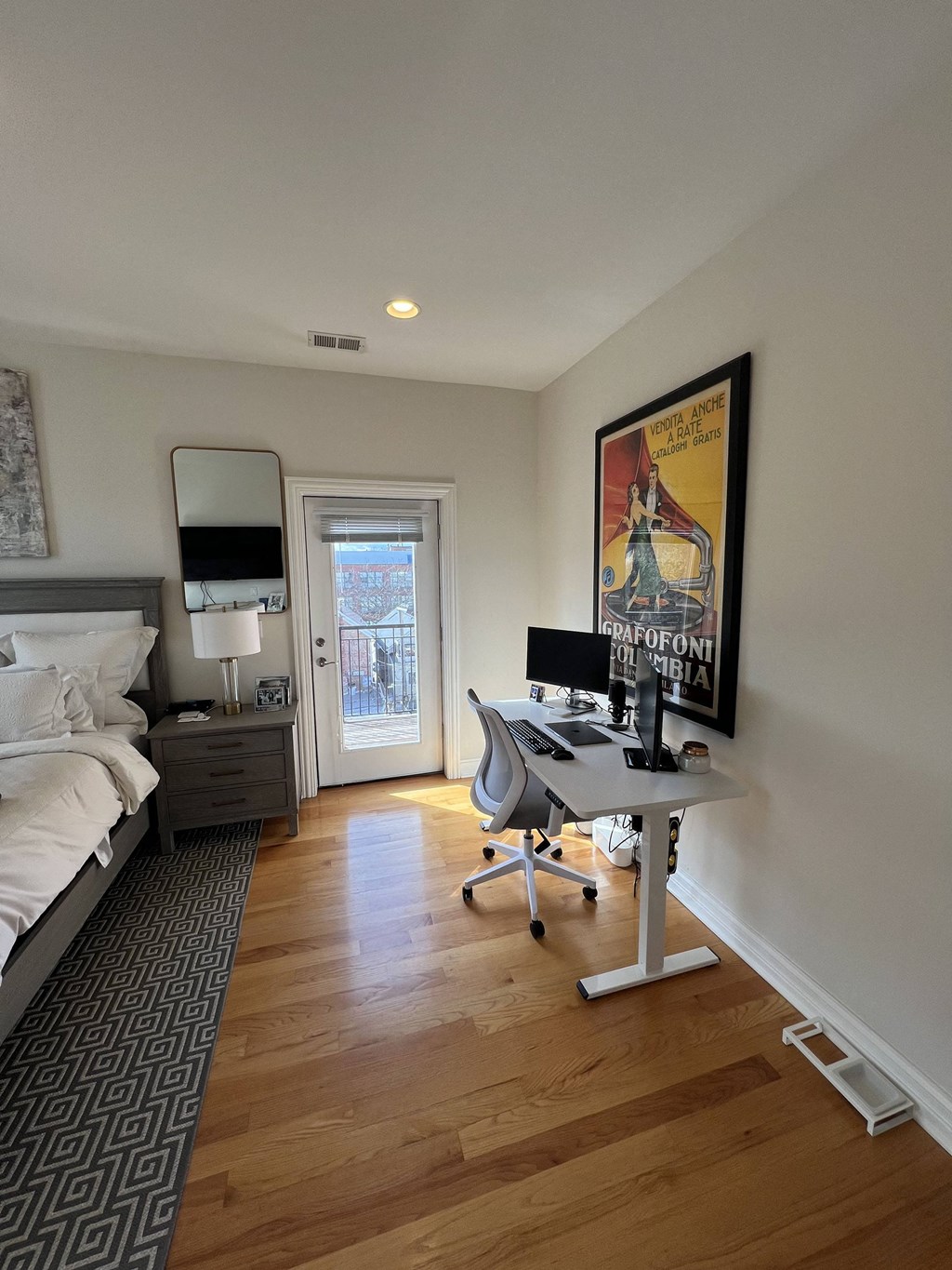 a bedroom with a desk and a bed in a room