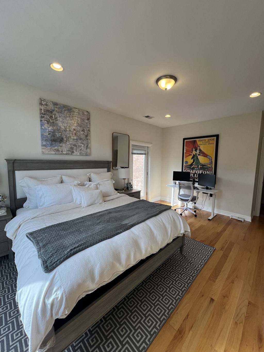 a bedroom with a bed and a desk and a piano