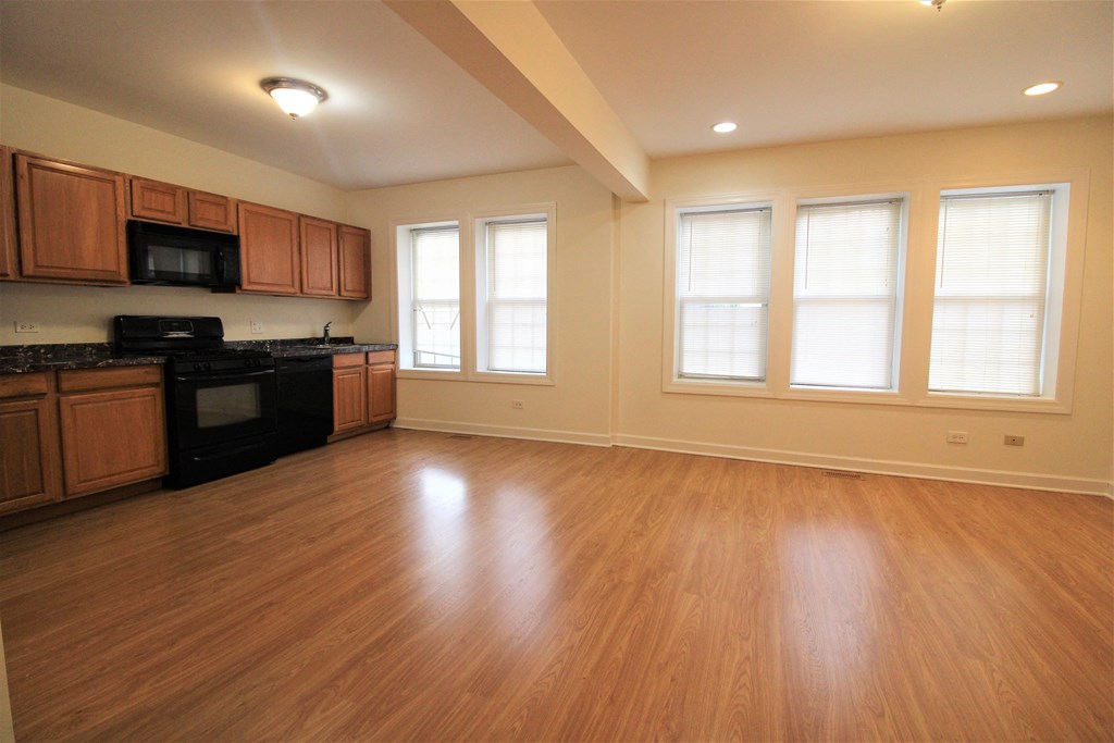 an empty kitchen with wood flooring and a large window at Christiana 4954, Chicago Illinois at Christiana 4954, Chicago