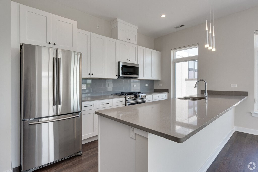 a kitchen with white cabinets and stainless steel appliances  at Highwood 246, Highwood