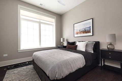 a bedroom with a large bed and a window