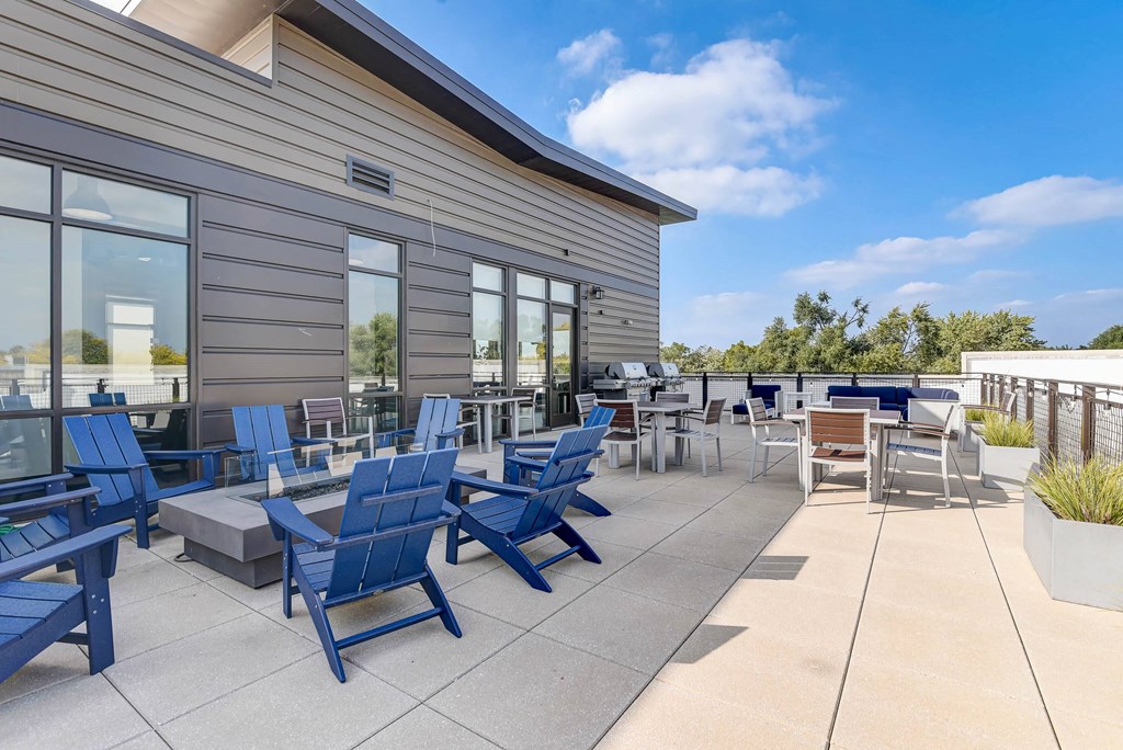 the patio of the building has blue chairs and tables at Barrington 101, Chicago
