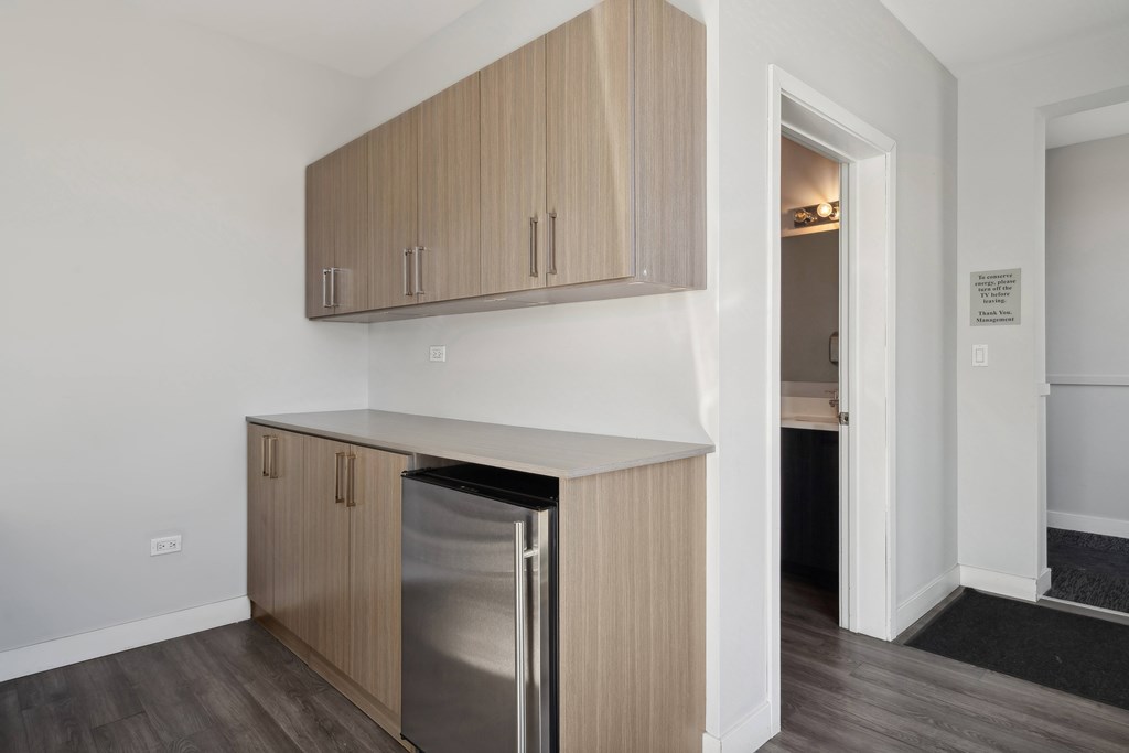 Community room kitchen at Highpoint Buena Park on Broadway with stainless steel appliances, bar seating, and modern cabinetry in a stylish shared space for residents in Chicago’s Buena Park neighborhood