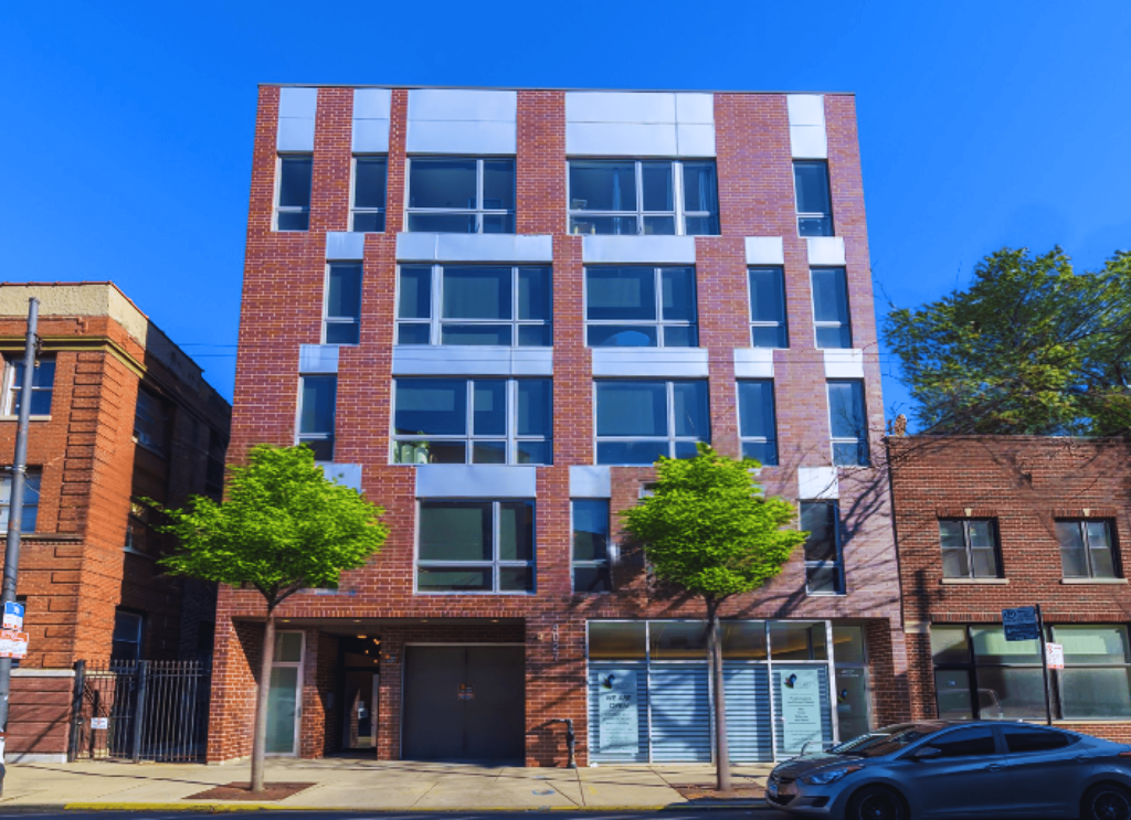 Four-story apartment building at Highpoint Buena Park on Broadway with modern brick façade, located near Wrigley Field, Montrose Beach, and the Sheridan Red Line Station in Chicago’s Buena Park neighborhood